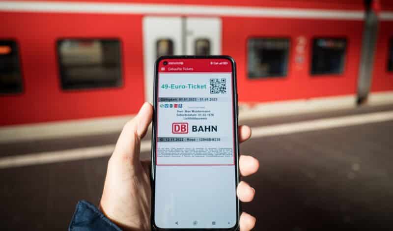 Smartphone mit 49-Euro-Ticket vor Sbahn