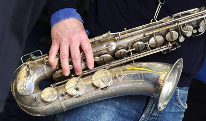 Nahaufnahme eines Saxofons, das ein Mann festhält