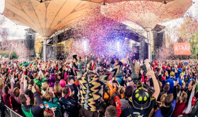 Das Foto zeigt Besucher im Kölner Tanzbrunnen, die vor der Bühne die Eröffnung des Kölner Karnevals feiern.