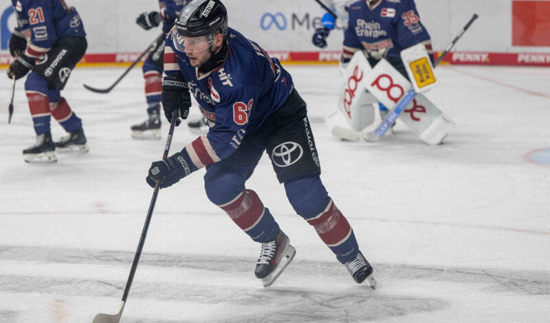 Ein Spieler der Kölner Haie spielt den Puck