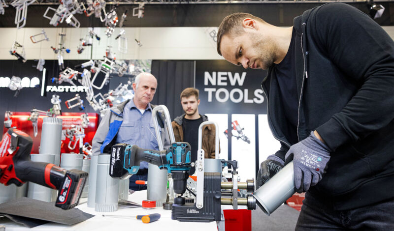 Ein Aussteller präsentiert auf der Messe DACH + HOLZ die Verwendung von Werkzeug