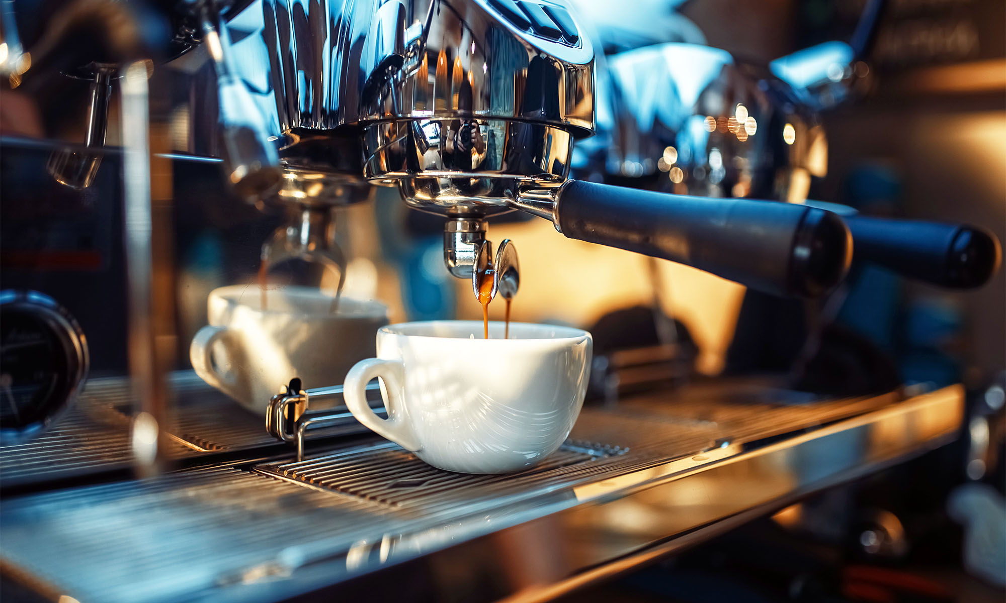 An einem Kaffeevollautomaten läuft Espresso in eine kleine Tasse