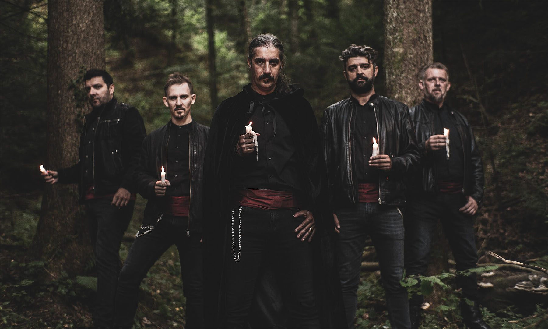 Die Sänger der A-cappella-Gruppe Metaklapa stehen in einem Wald.