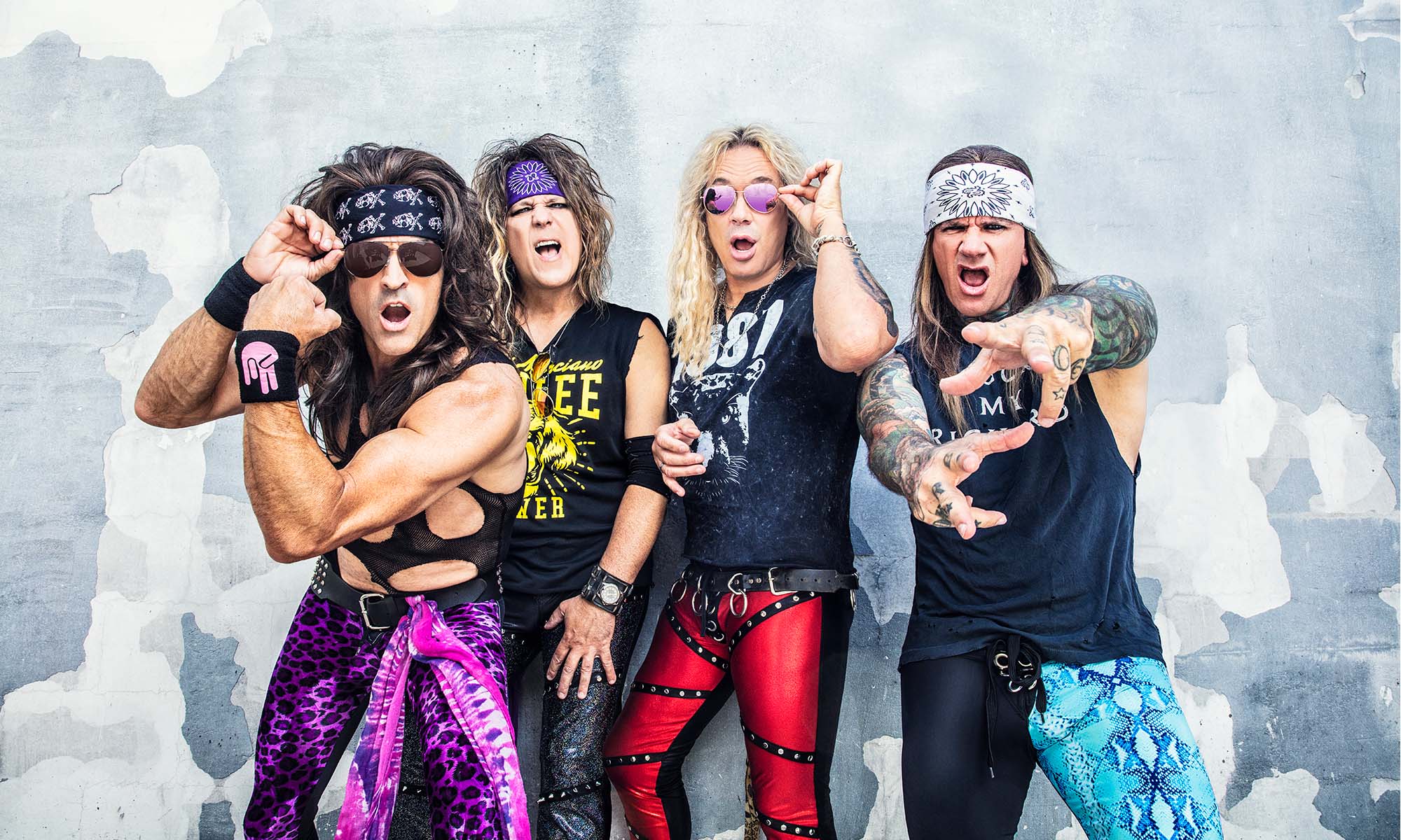 Die Musiker der amerikanischen Glam-Metal-Band Steel Panther posieren vor einer Mauer